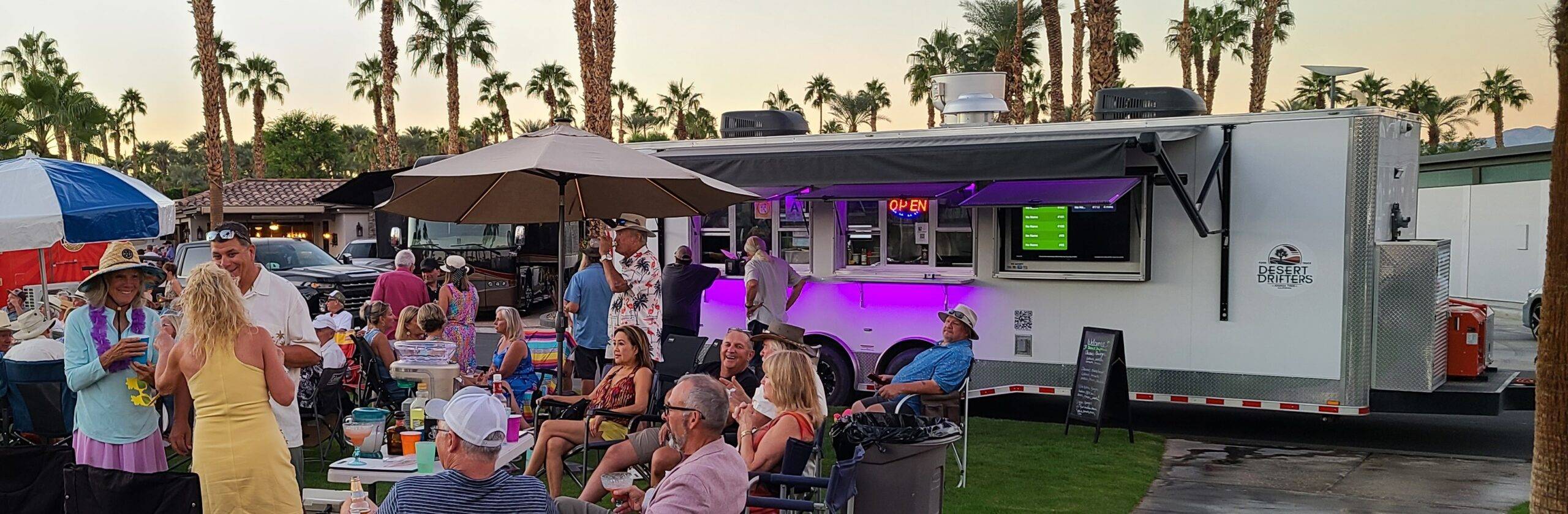 Guests beside the trailer at an outdoor party
