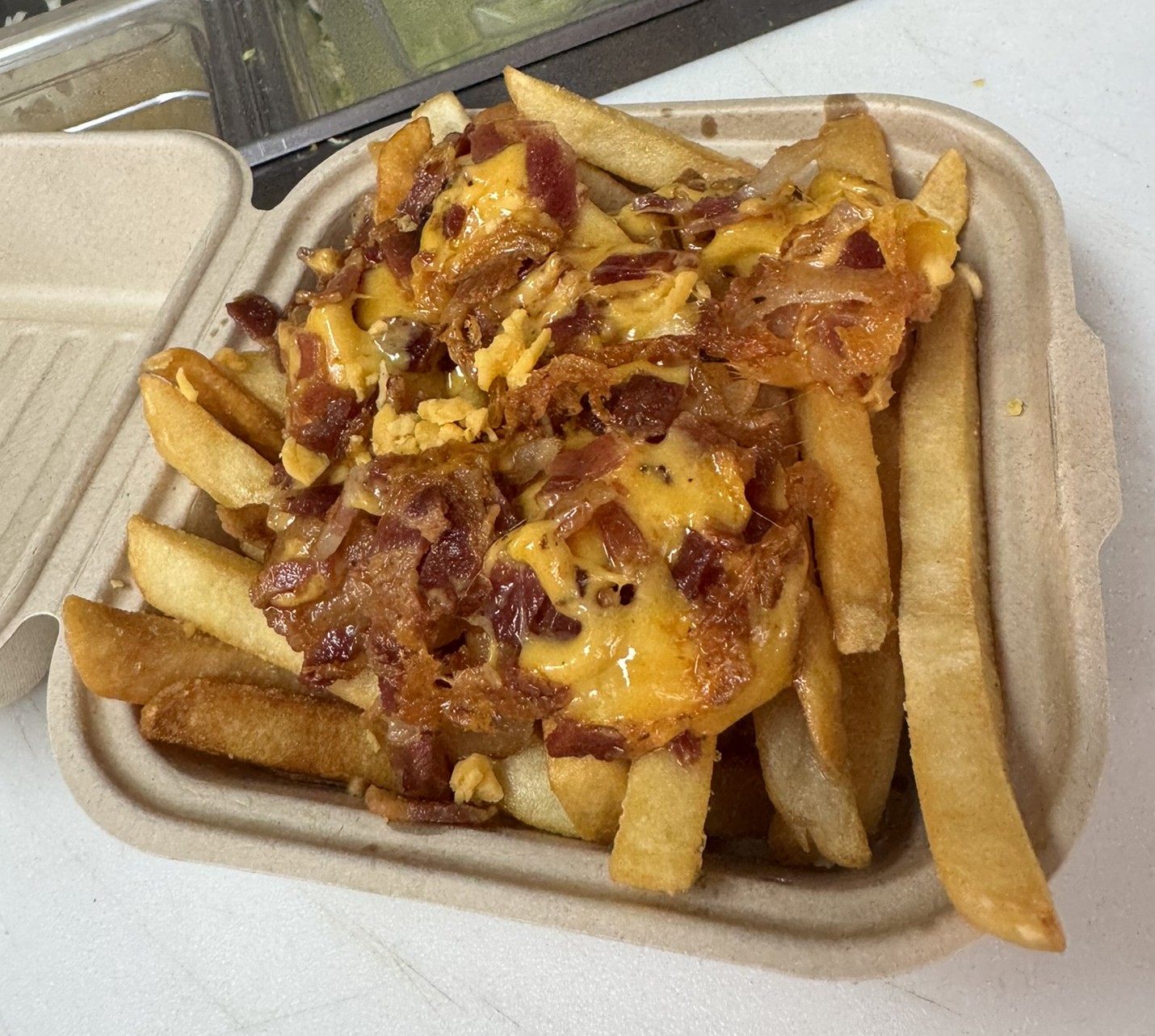 Fries loaded with cheese, bacon, and onion